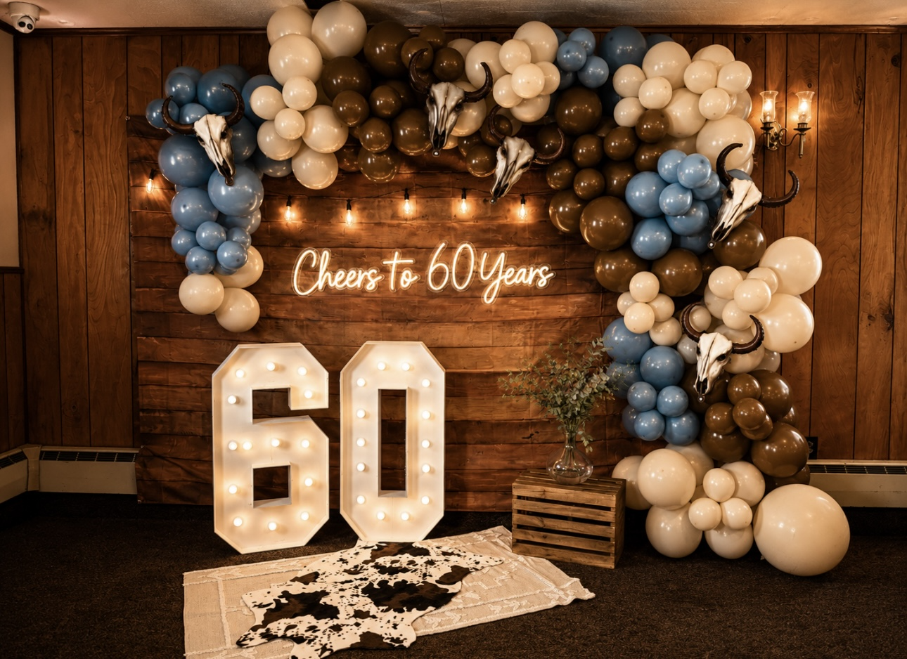 Decorated anniversary event setup with balloons and illuminated sign
