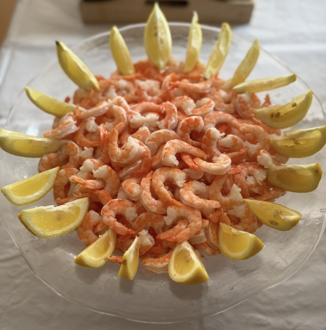 Chilled shrimp platter with lemon wedges