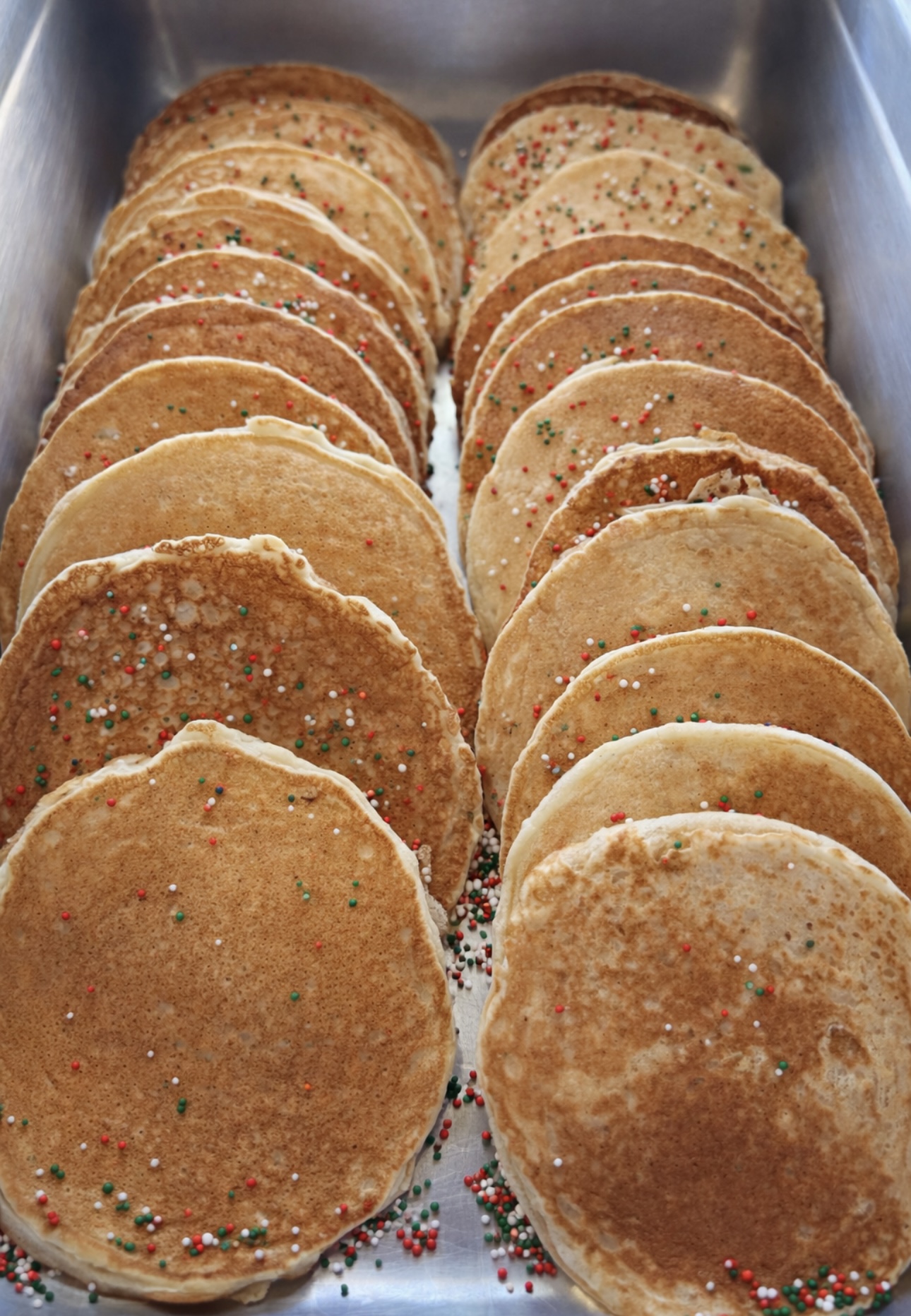 Tray of mini pancake rounds topped with holiday sprinkles