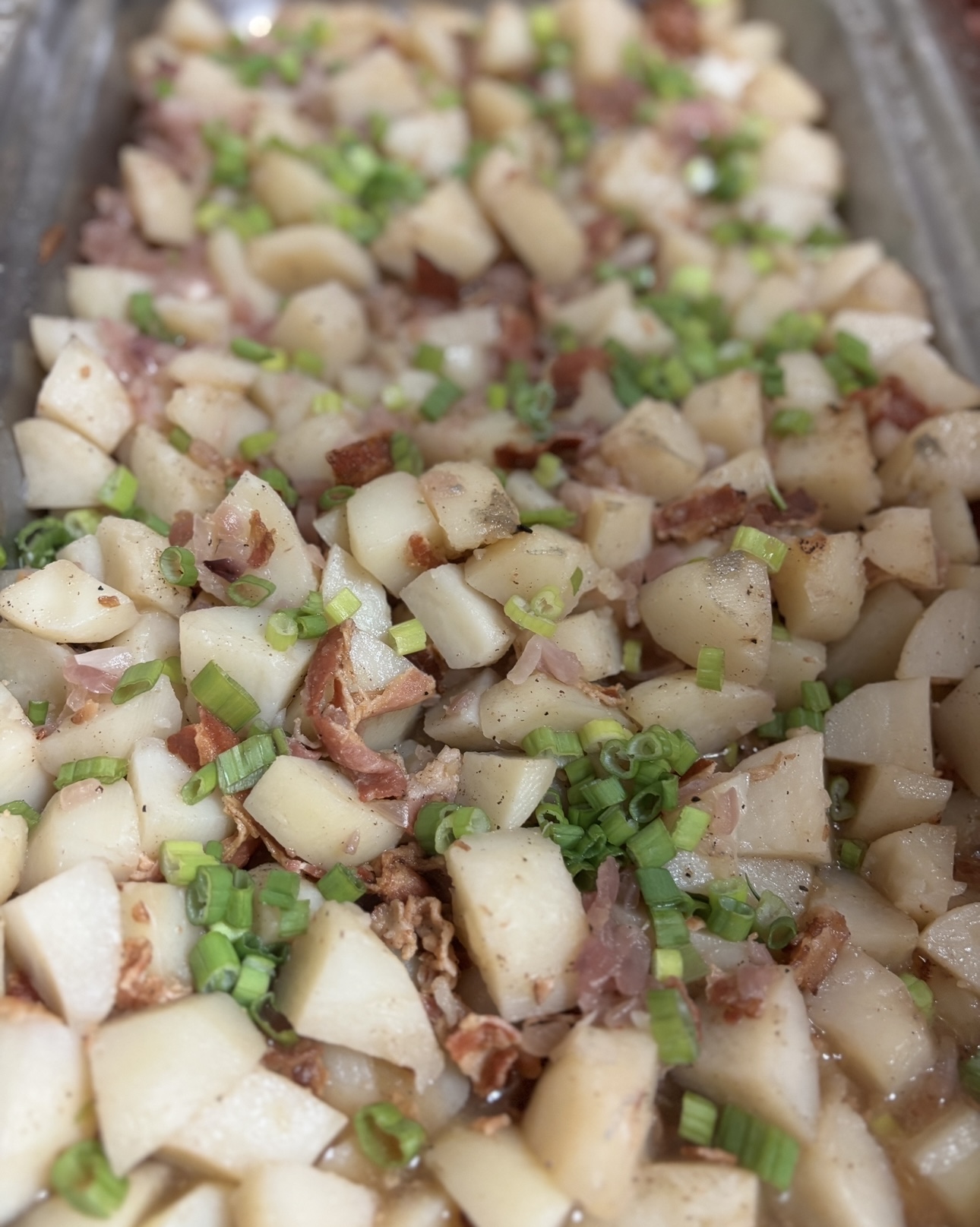 Diced potatoes with bacon and fresh scallions