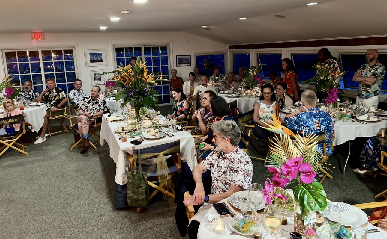 Guests seated at a tropical themed dinner party