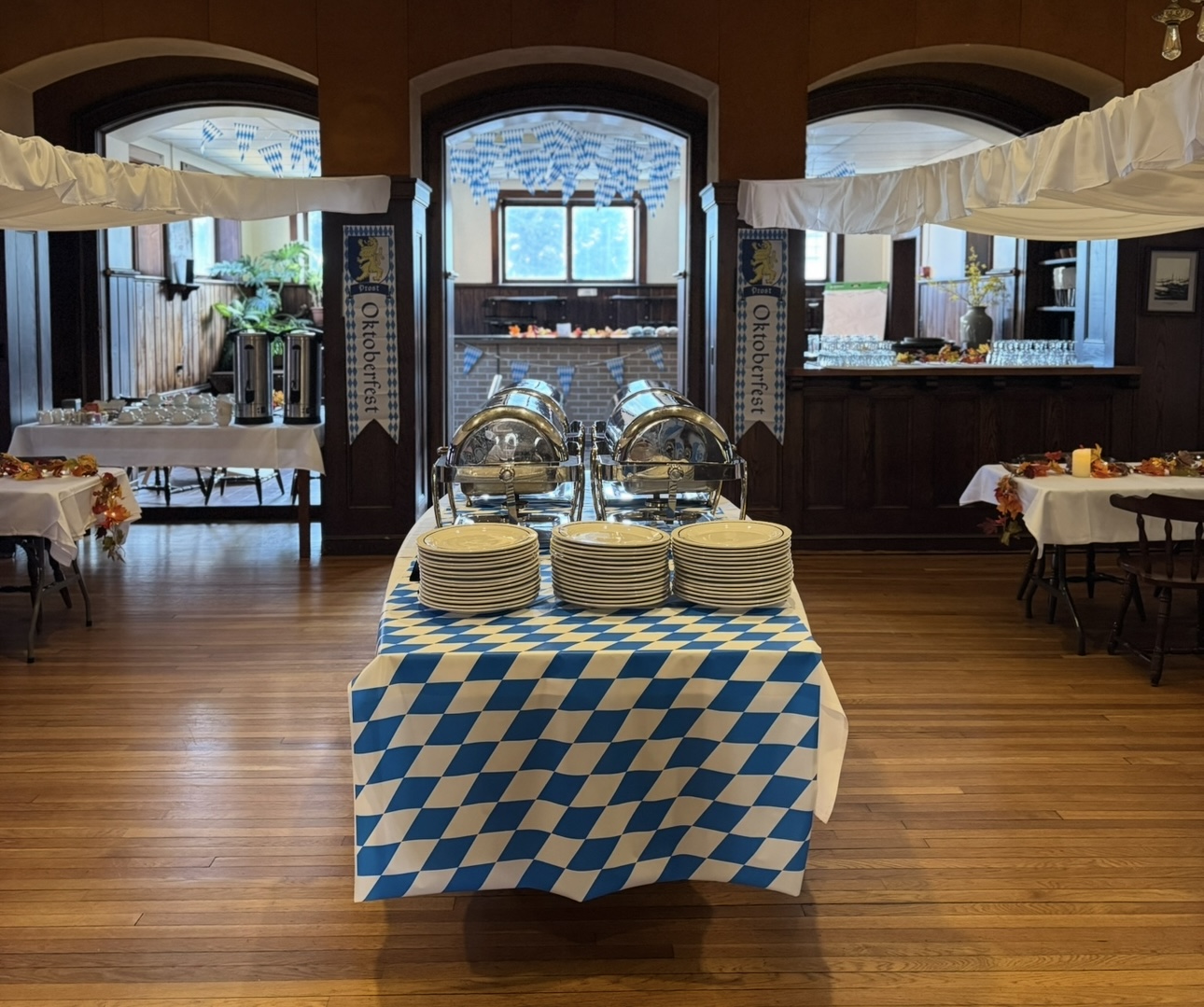 Oktoberfest buffet table with checkered linens and plate stacks