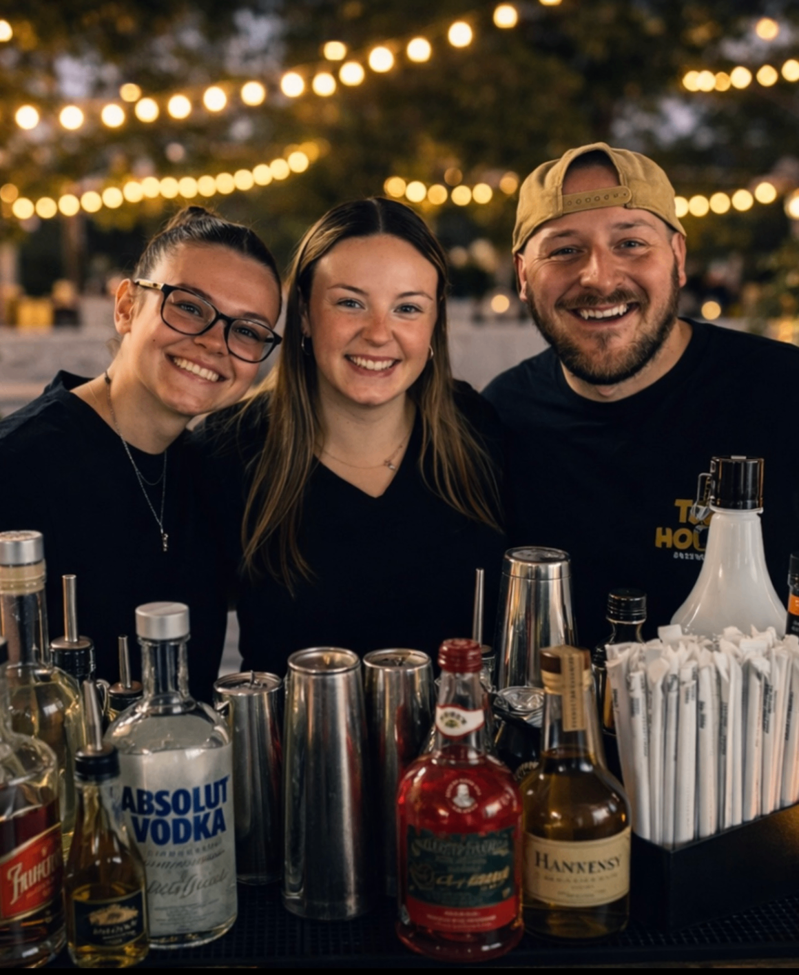 The Pour Decisions team smiling behind the bar