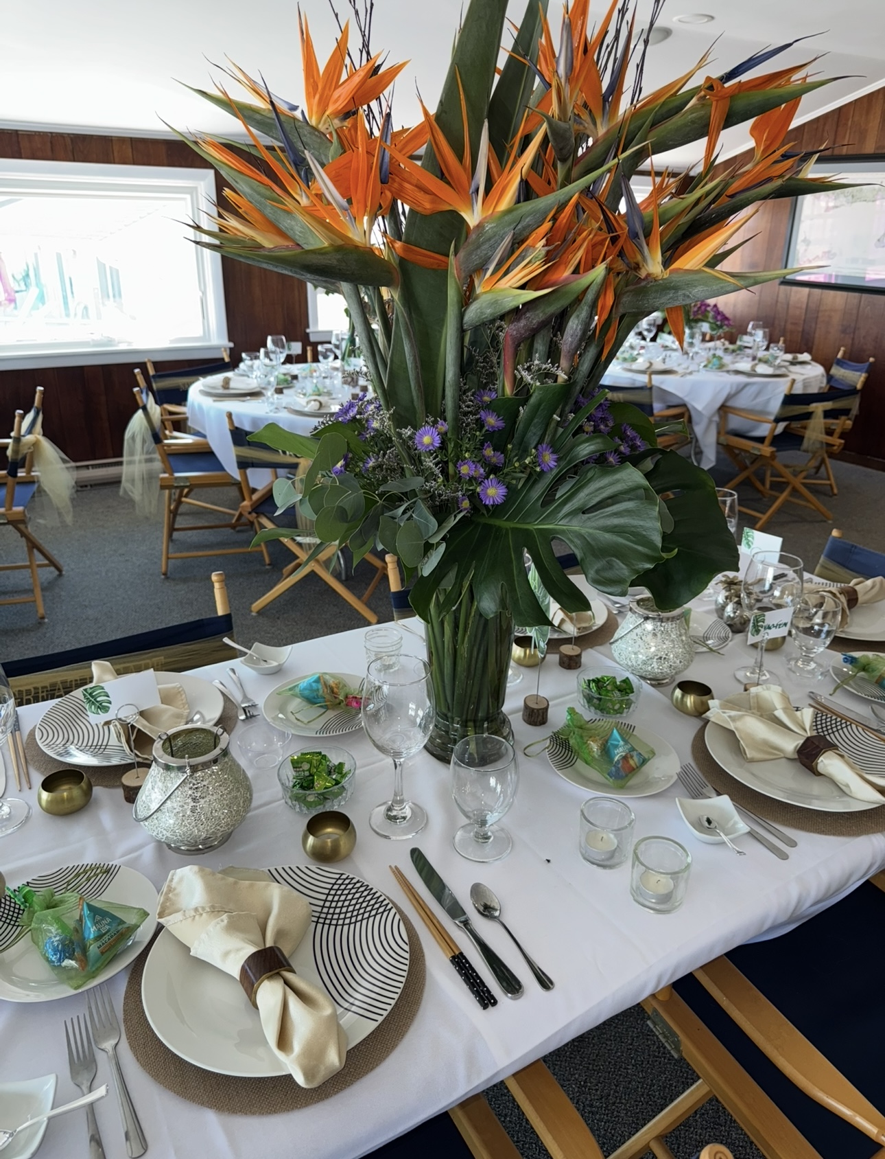 Towering bird of paradise floral centerpiece on a tropical tablescape