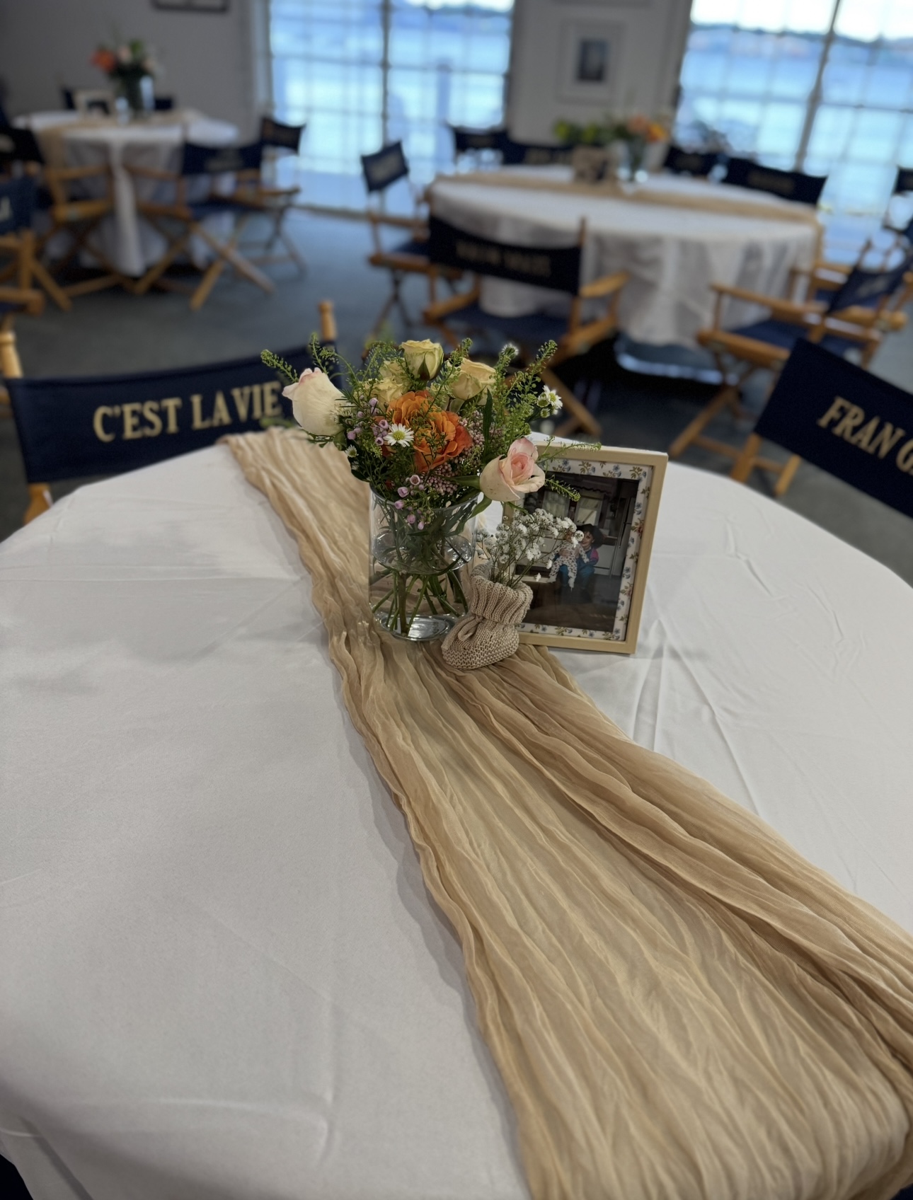 Floral centerpiece on a styled event table by the water